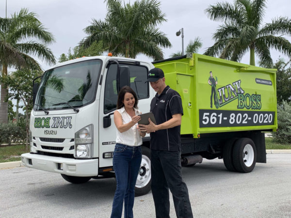 junk boss junk removal expert quoting customer for services